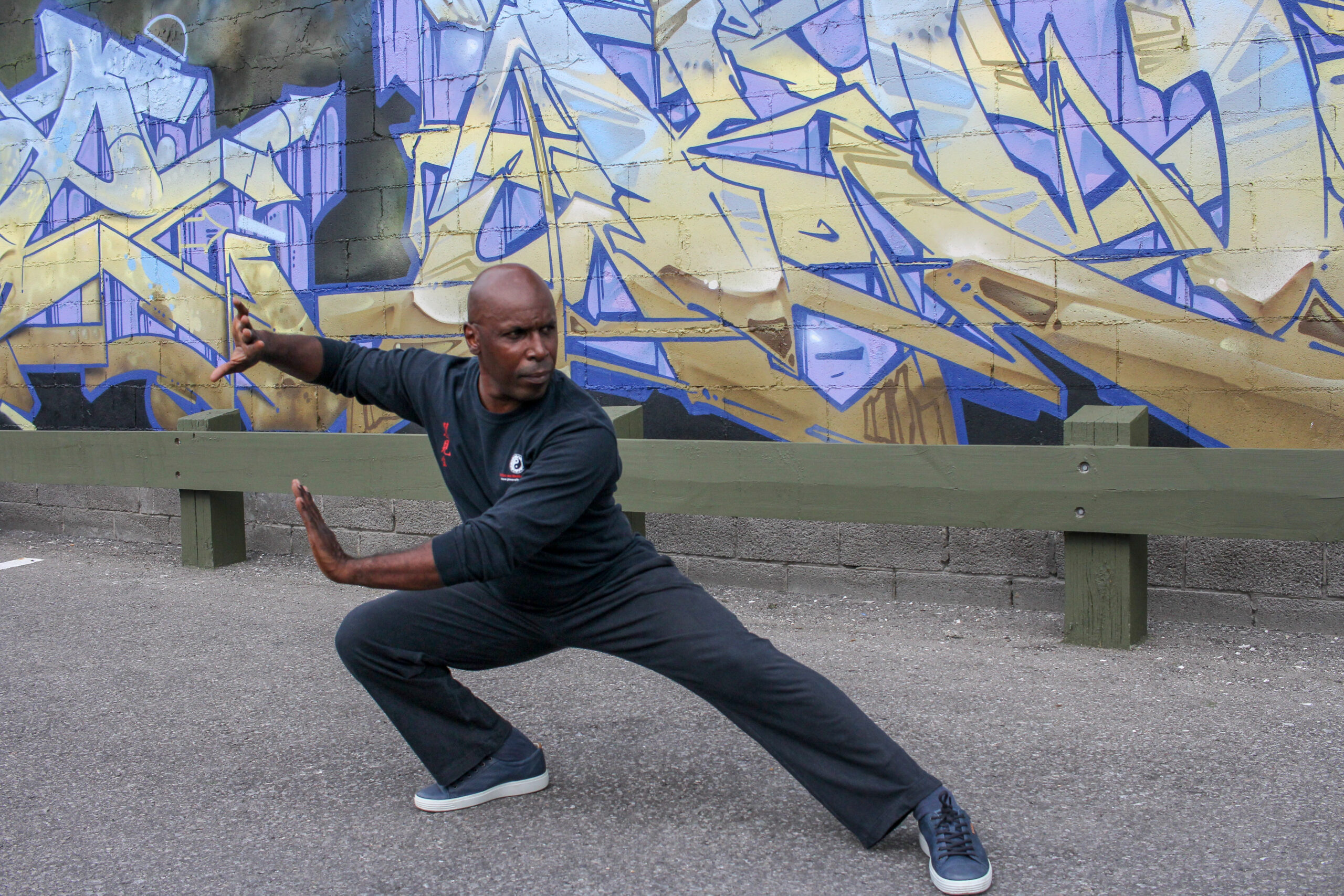 Qigong - Cultivating Qi and Vitality Dondrub Wangchuk demonstrating a Qigong pose with focused intention and mindful movement.