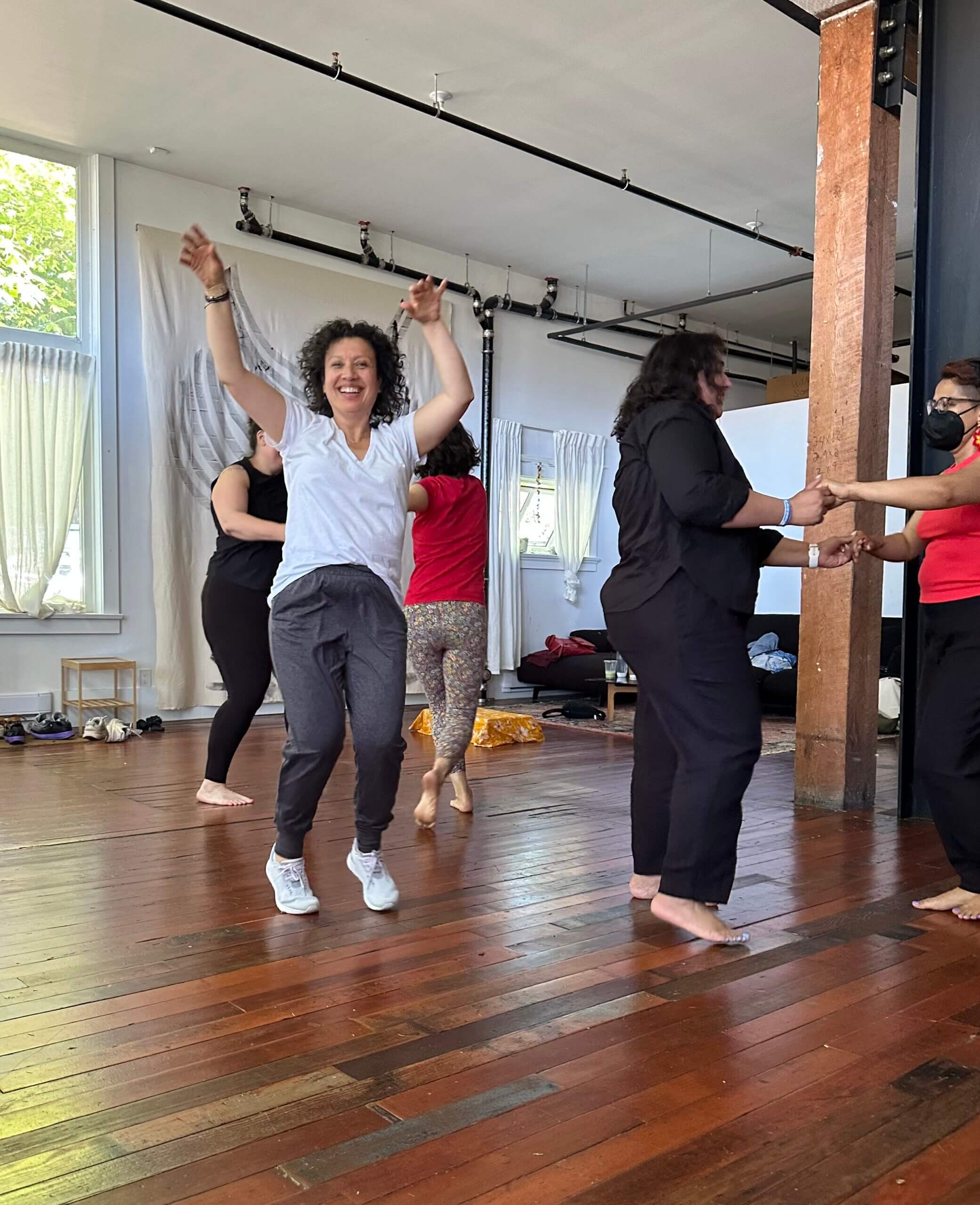 Students joyfully participating in a Biodanza class, expressing vitality and creativity.